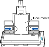 Holding Each Side Guide in the Middle to Adjust Them